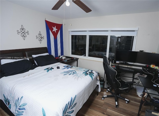 bedroom with dark wood-style floors and ceiling fan