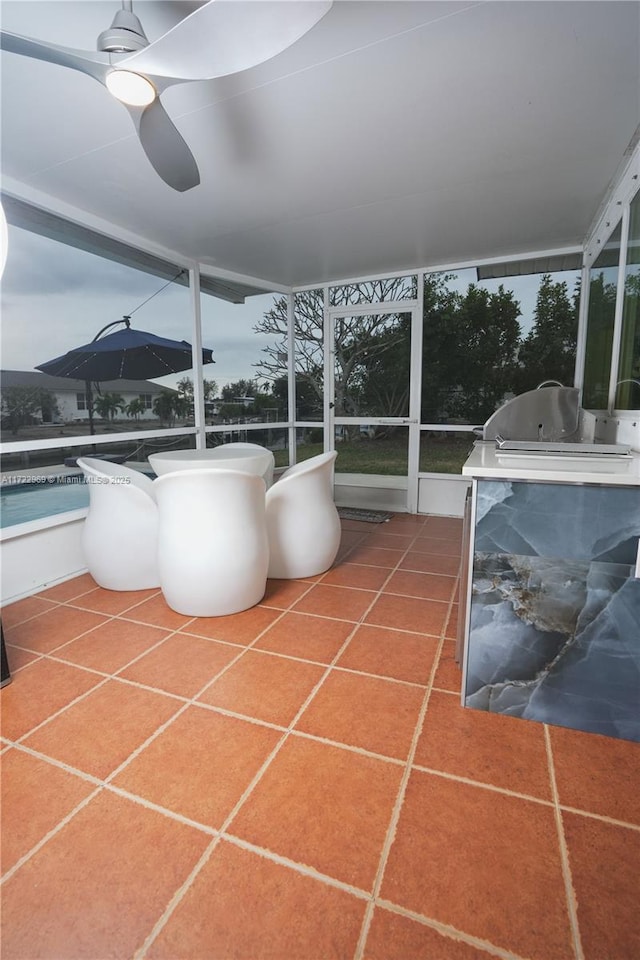 unfurnished sunroom with a ceiling fan