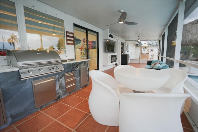 sunroom featuring ceiling fan