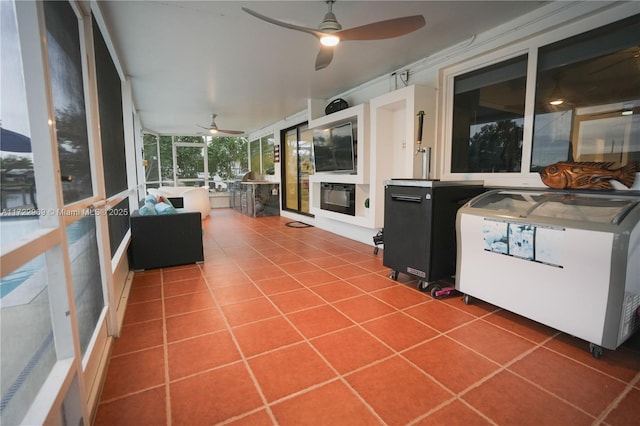 unfurnished sunroom featuring ceiling fan