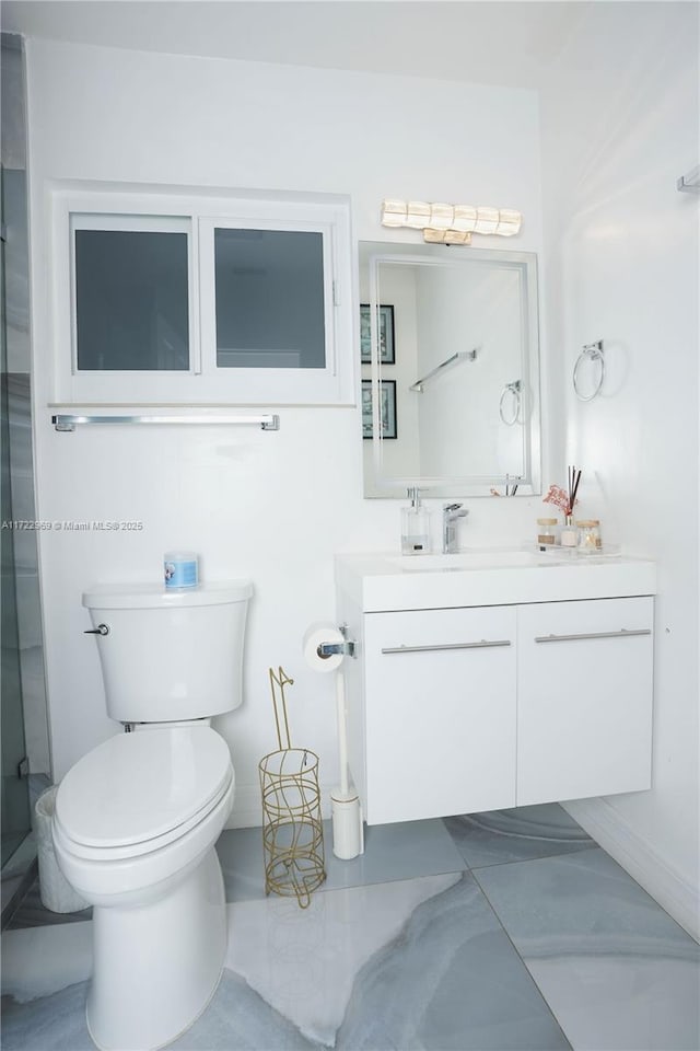 full bathroom with toilet, marble finish floor, and vanity