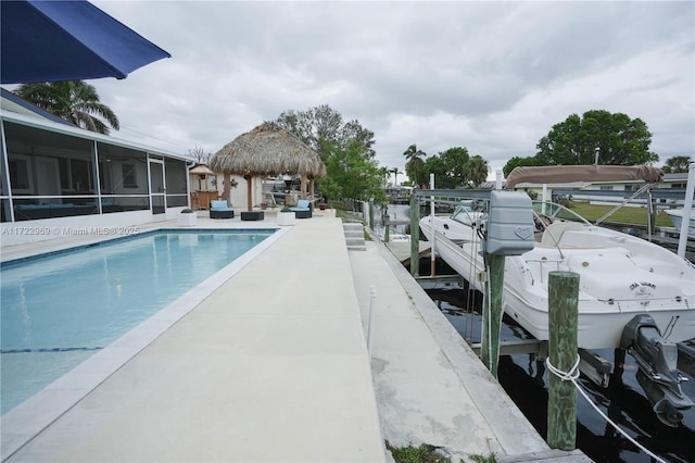 outdoor pool featuring a dock, boat lift, and a gazebo