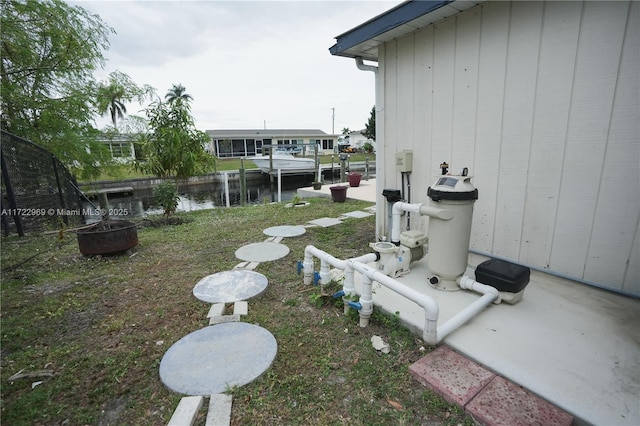 view of yard with a water view and an outdoor fire pit