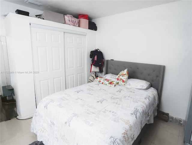 bedroom featuring a closet and light tile patterned floors