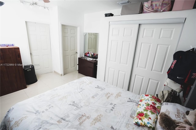 bedroom with a closet and light tile patterned floors