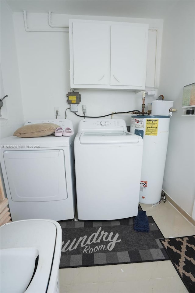 washroom featuring water heater, cabinet space, and separate washer and dryer