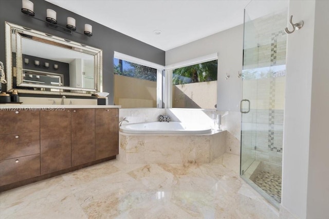 bathroom featuring vanity and independent shower and bath