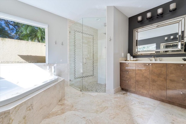 bathroom featuring vanity and separate shower and tub