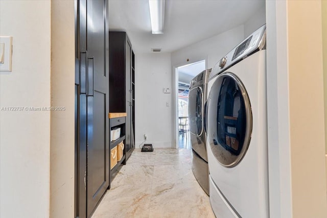 clothes washing area featuring washing machine and clothes dryer