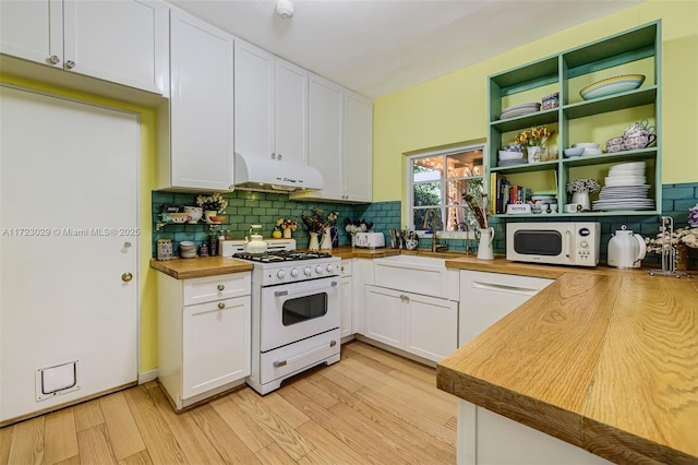 kitchen with wooden counters, tasteful backsplash, white appliances, sink, and white cabinets