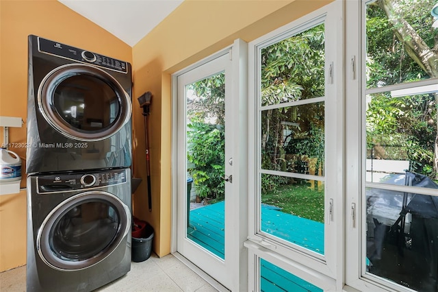 laundry room featuring stacked washer / drying machine