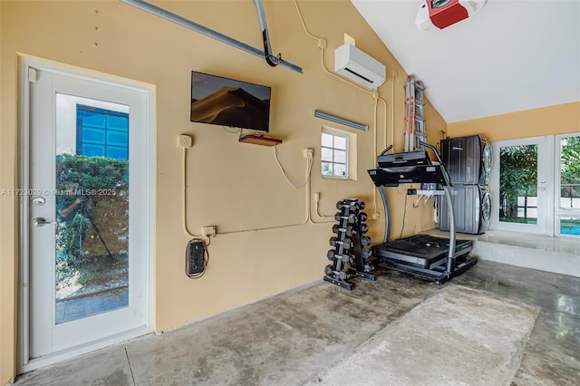 workout room featuring vaulted ceiling, a wall unit AC, and a wealth of natural light