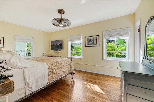 bedroom with light wood-type flooring and multiple windows