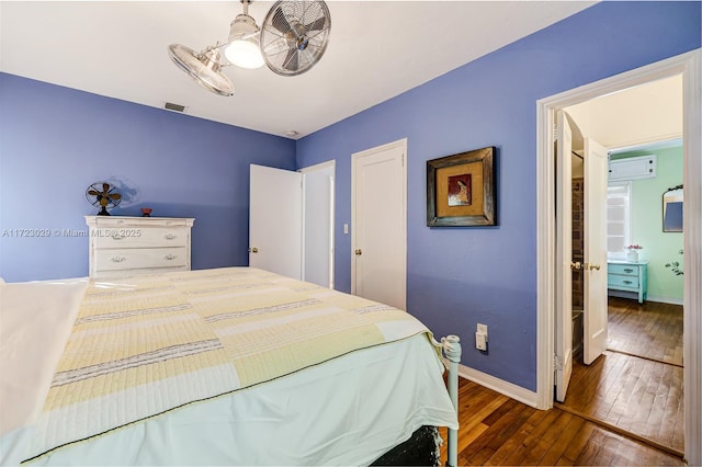 bedroom featuring dark wood-type flooring and a wall mounted AC