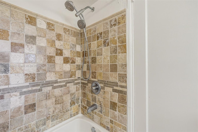 bathroom featuring tiled shower / bath