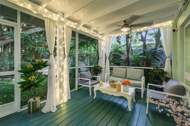 sunroom with beam ceiling and ceiling fan