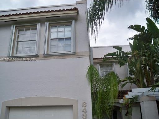 view of property exterior featuring a garage