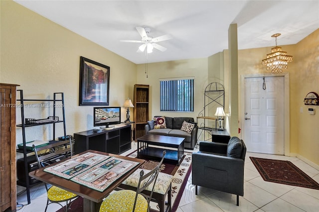 living room featuring light tile patterned floors and ceiling fan with notable chandelier