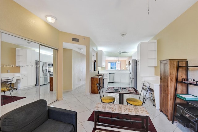 living room with ceiling fan and light tile patterned floors