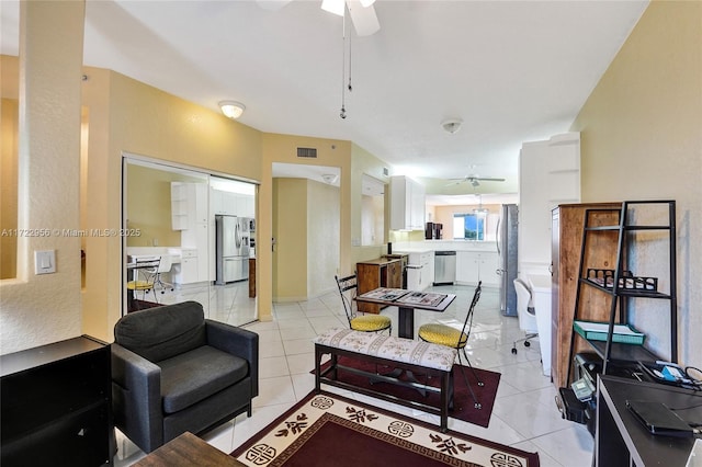 living room with ceiling fan and light tile patterned floors