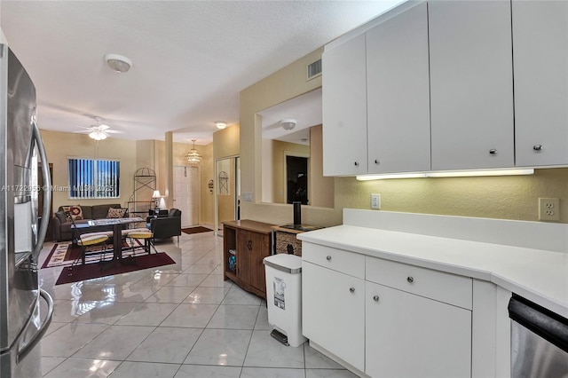 kitchen with ceiling fan, stainless steel appliances, white cabinets, a textured ceiling, and light tile patterned floors