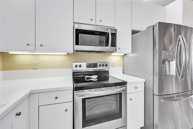 kitchen featuring white cabinetry and appliances with stainless steel finishes