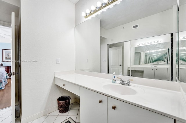 bathroom with tile patterned flooring and vanity