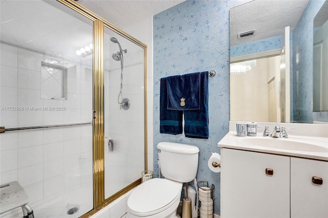 bathroom with a shower with door, a textured ceiling, and toilet