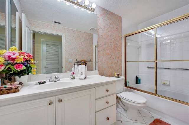 full bathroom featuring vanity, a textured ceiling, shower / bath combination with glass door, tile patterned flooring, and toilet