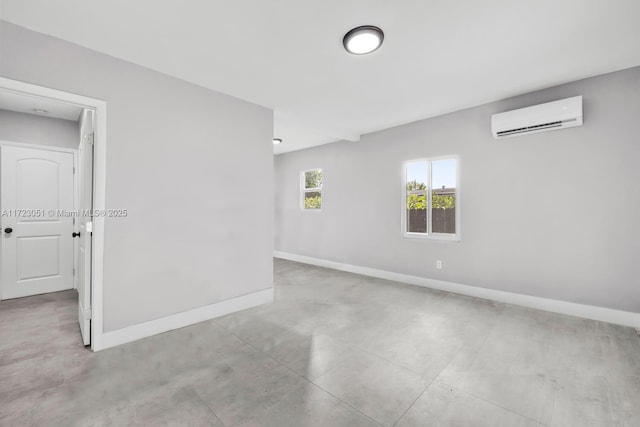 unfurnished room featuring a wall mounted AC