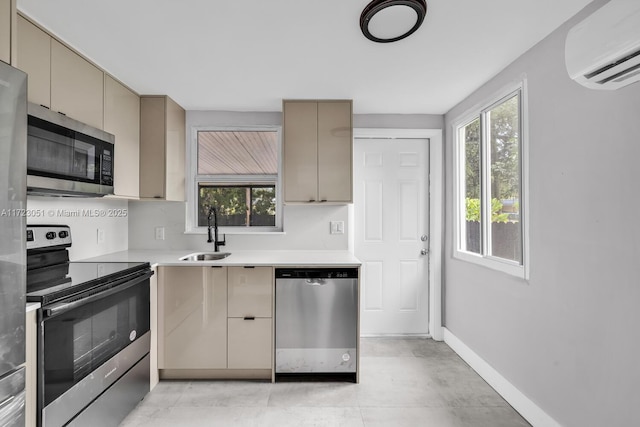 kitchen with appliances with stainless steel finishes, an AC wall unit, and sink