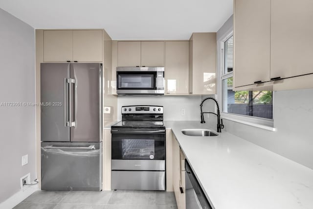 kitchen featuring light tile patterned flooring, sink, and appliances with stainless steel finishes