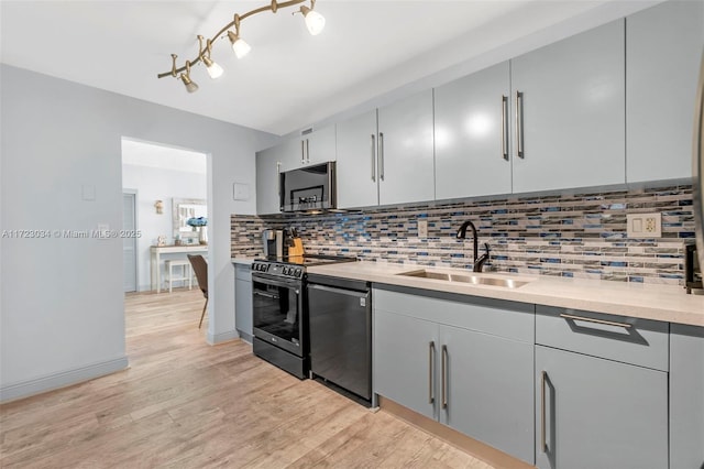 kitchen with range with electric stovetop, stainless steel microwave, decorative backsplash, a sink, and dishwashing machine