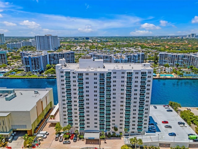 birds eye view of property with a water view and a city view