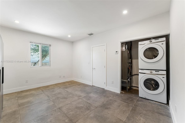 laundry room featuring stacked washer / drying machine