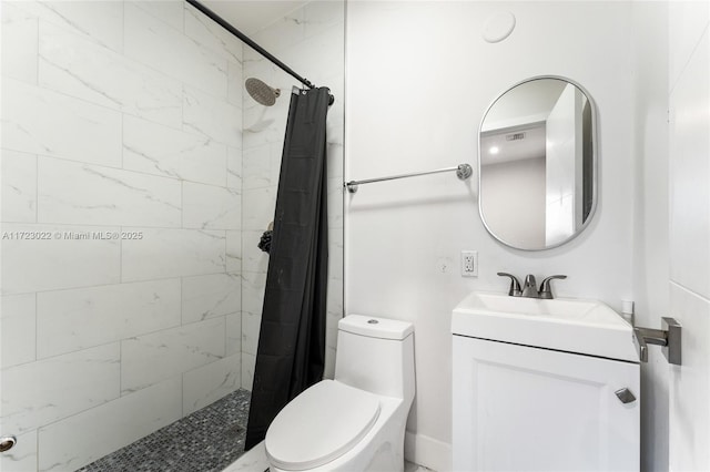 bathroom featuring vanity, curtained shower, and toilet