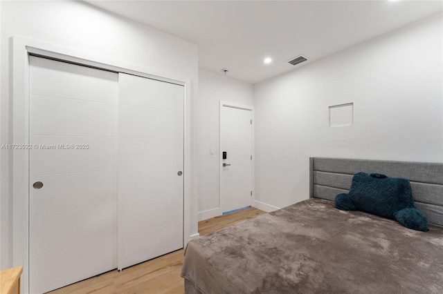 bedroom with a closet and hardwood / wood-style flooring