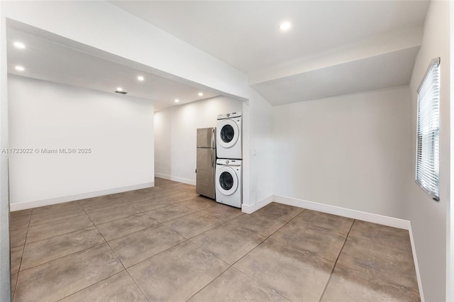 washroom featuring stacked washer and clothes dryer