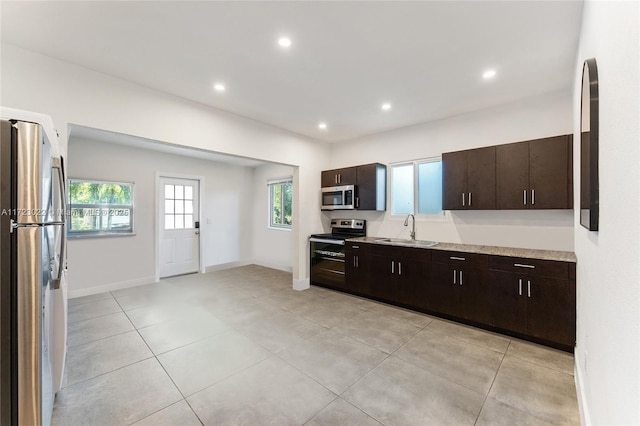 kitchen with dark brown cabinetry, sink, and appliances with stainless steel finishes