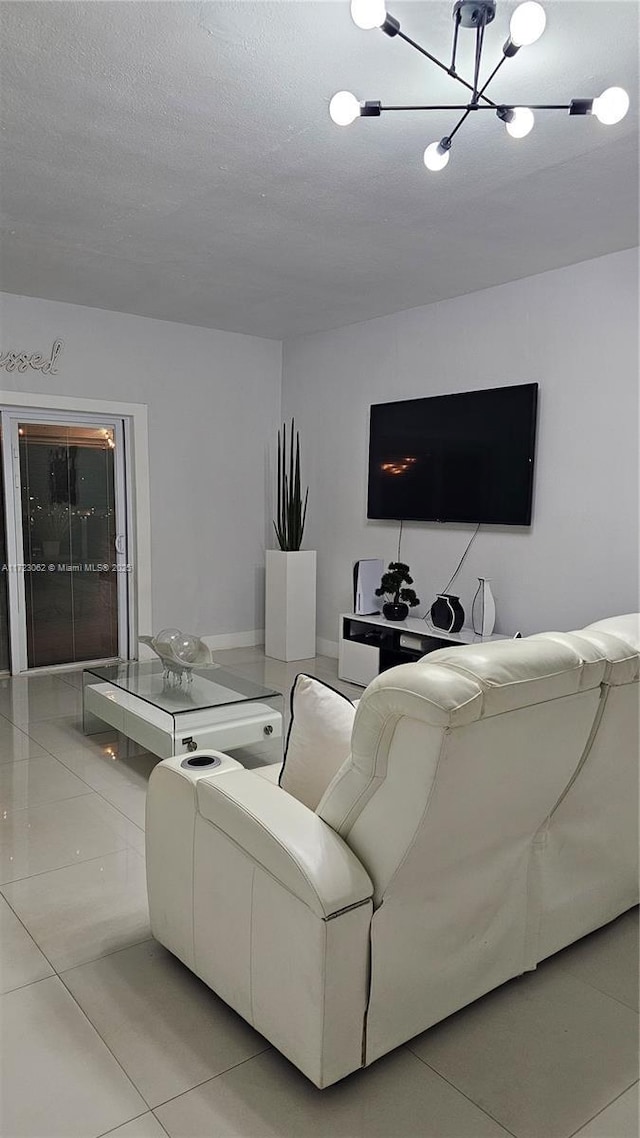 living room with a chandelier and light tile patterned flooring