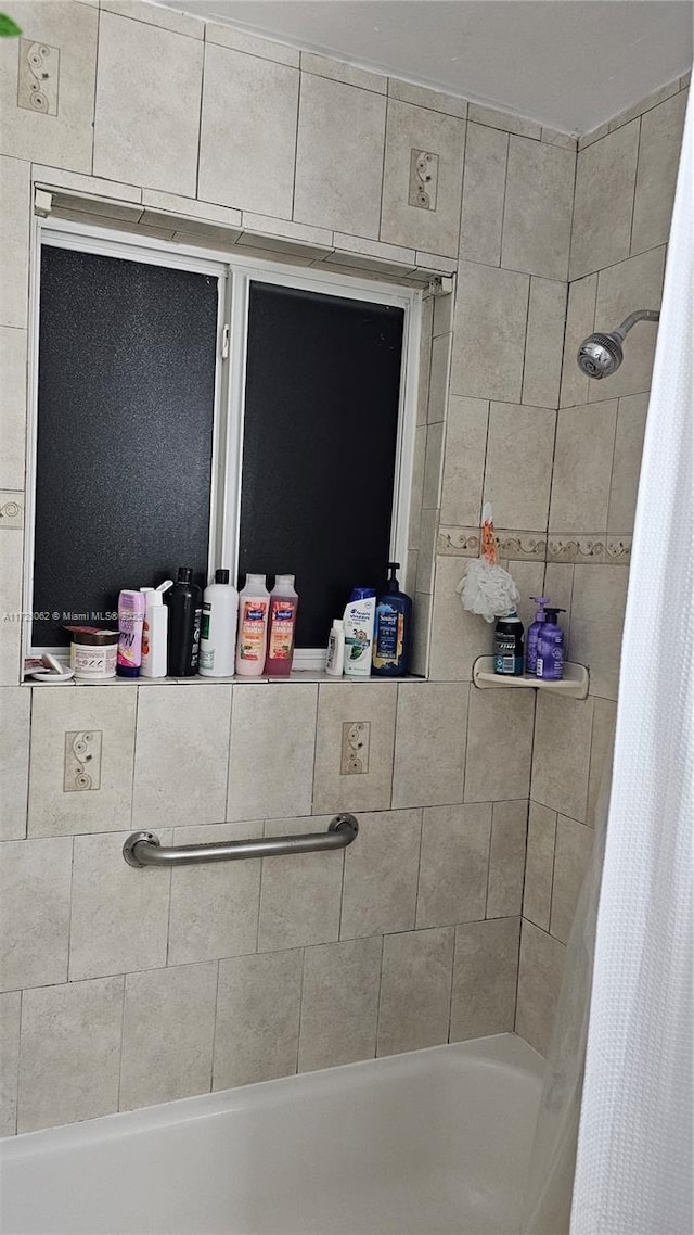 bathroom featuring shower / bath combo with shower curtain