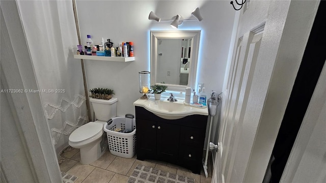 bathroom with tile patterned floors, vanity, and toilet