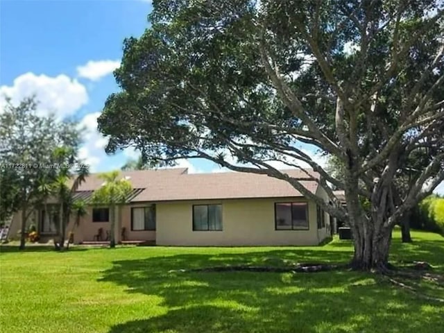 back of house with a yard