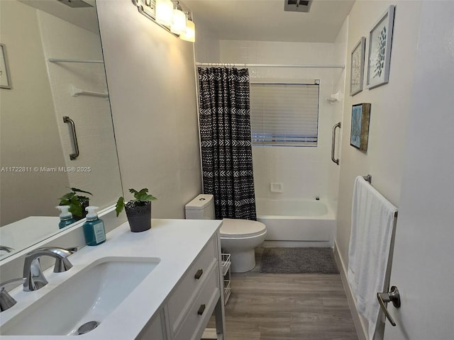 full bathroom featuring toilet, hardwood / wood-style floors, vanity, and shower / tub combo with curtain