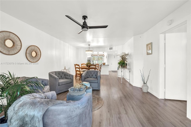 living room featuring hardwood / wood-style floors and ceiling fan