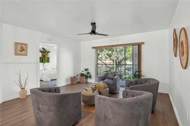 living room featuring wood-type flooring and ceiling fan