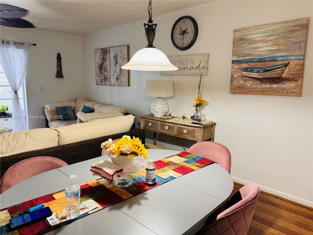 dining area with dark hardwood / wood-style flooring