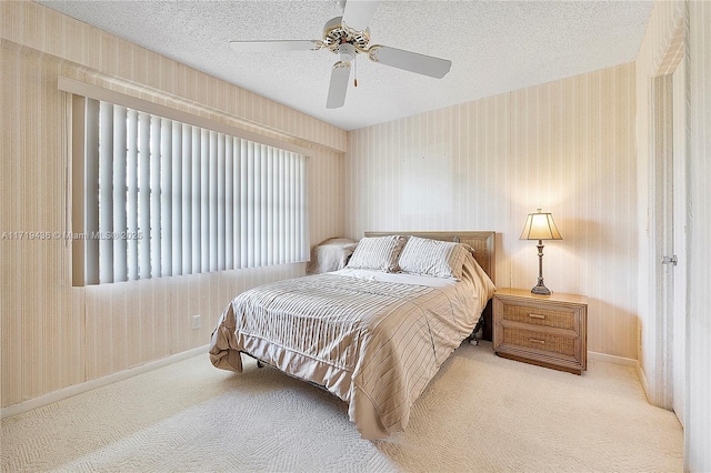 carpeted bedroom with a textured ceiling and ceiling fan