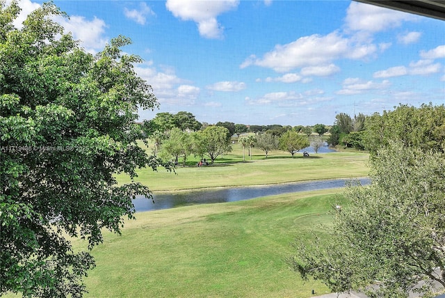 surrounding community featuring a lawn and a water view