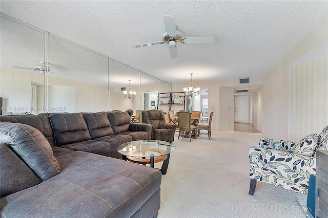 living room with ceiling fan with notable chandelier, a textured ceiling, and light colored carpet